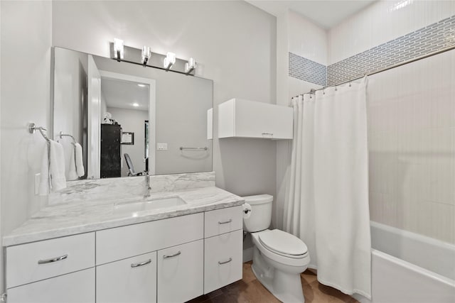 full bathroom featuring toilet, shower / bathtub combination with curtain, and vanity