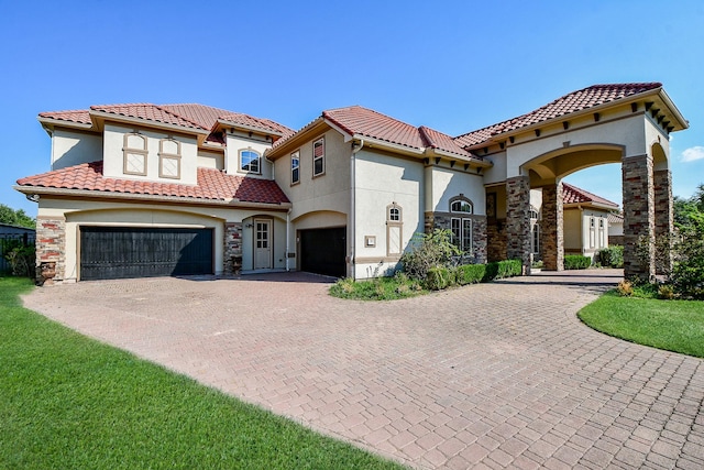 mediterranean / spanish-style home with a garage