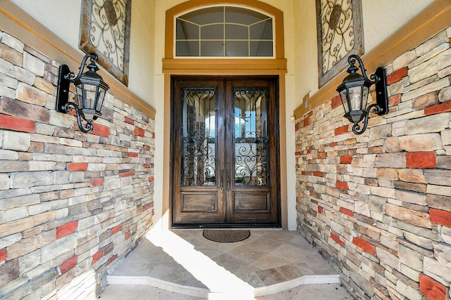 view of exterior entry featuring french doors