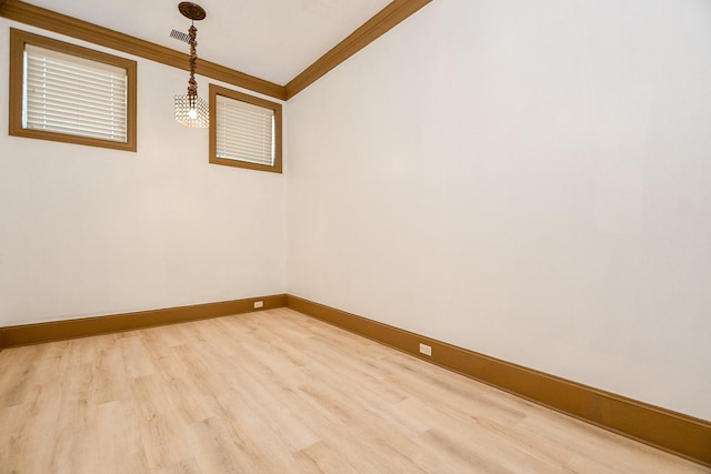 empty room with wood-type flooring and ornamental molding