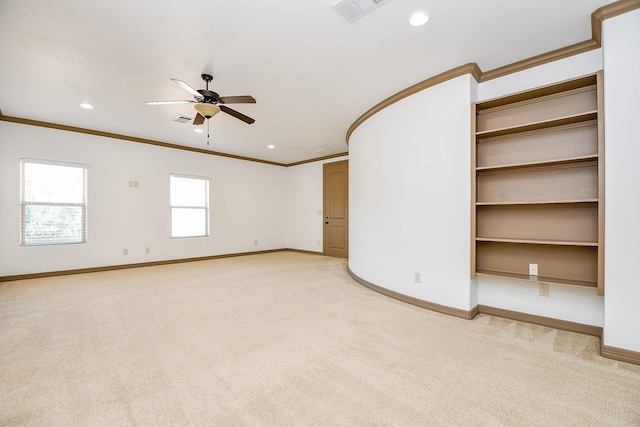 unfurnished room with light carpet, crown molding, and ceiling fan