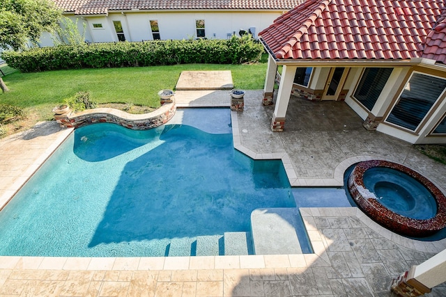 view of pool with a patio area, an in ground hot tub, and a yard