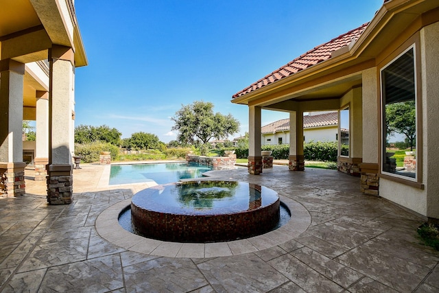 view of patio with a swimming pool with hot tub