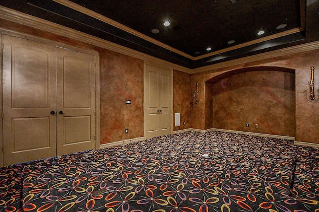 interior space with a raised ceiling and crown molding