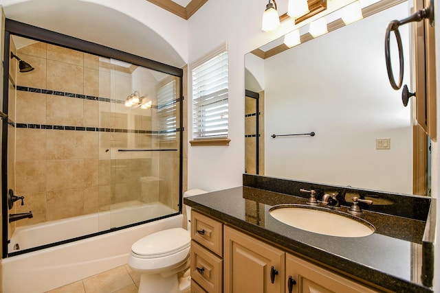 full bathroom with vanity, combined bath / shower with glass door, crown molding, tile patterned flooring, and toilet