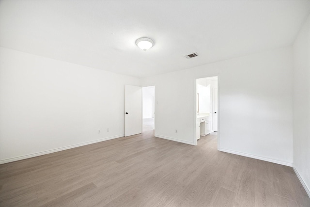 unfurnished room with light wood-type flooring