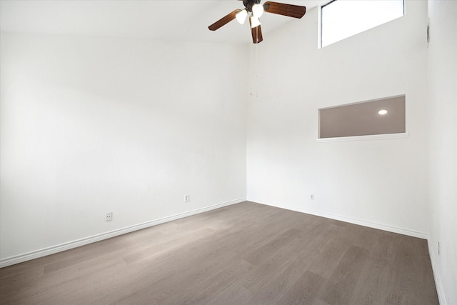 spare room with ceiling fan and dark wood-type flooring