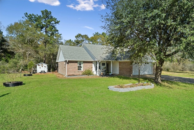 view of front of property with a front lawn and a storage unit