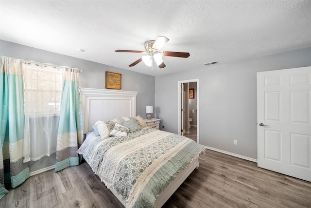 bedroom with ceiling fan, a textured ceiling, and hardwood / wood-style flooring