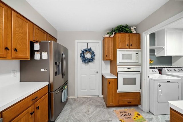 kitchen featuring separate washer and dryer and white appliances