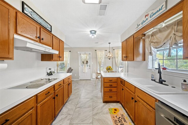 kitchen with sink, dishwasher, white stovetop, kitchen peninsula, and decorative light fixtures