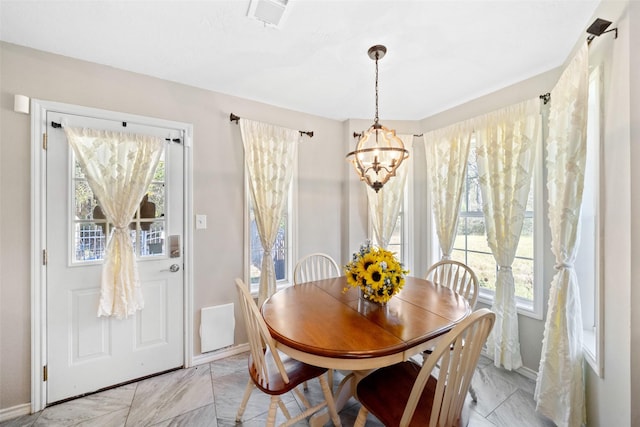 dining area with an inviting chandelier