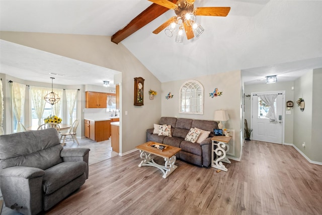 living room with ceiling fan, a healthy amount of sunlight, and light wood-type flooring