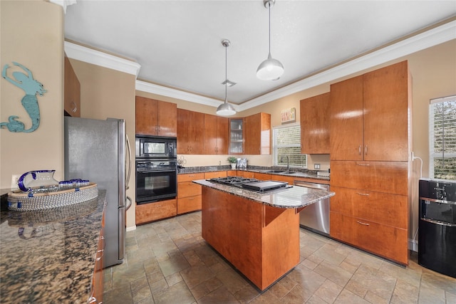 kitchen featuring a kitchen island, decorative light fixtures, sink, a kitchen bar, and black appliances