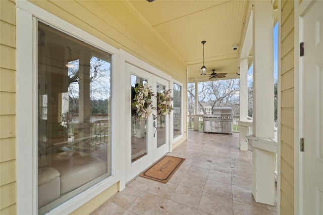 unfurnished sunroom with french doors, ceiling fan, plenty of natural light, and vaulted ceiling