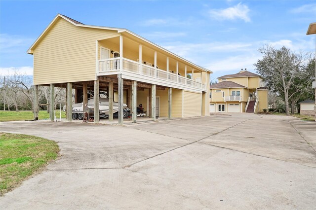 view of front of home featuring a carport and a balcony