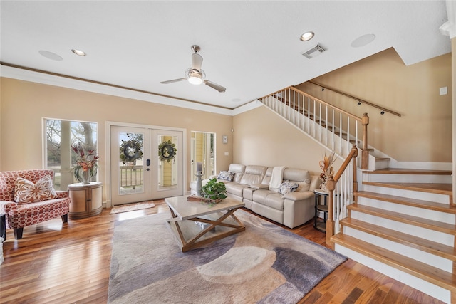 living room featuring crown molding, french doors, ceiling fan, and hardwood / wood-style flooring