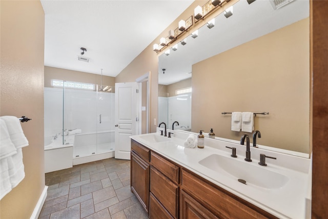 bathroom with plus walk in shower, a wealth of natural light, and vanity