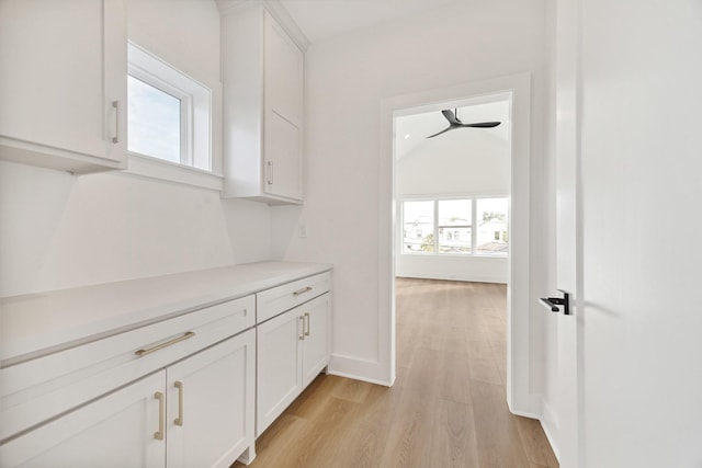 corridor with light hardwood / wood-style flooring