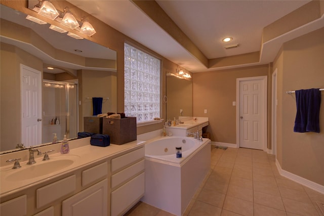 bathroom with a raised ceiling, tile patterned flooring, plus walk in shower, and vanity