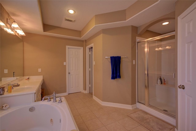 bathroom featuring separate shower and tub, tile patterned flooring, a raised ceiling, and vanity