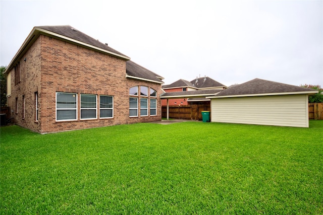 rear view of house featuring a lawn