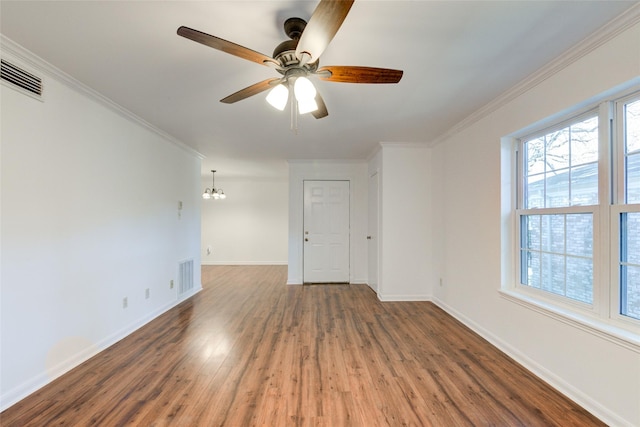 unfurnished room with dark hardwood / wood-style floors, ornamental molding, and ceiling fan with notable chandelier