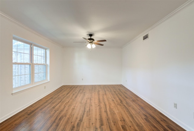 unfurnished room with ornamental molding, ceiling fan, and dark wood-type flooring