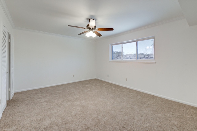 spare room with light carpet, ceiling fan, and ornamental molding