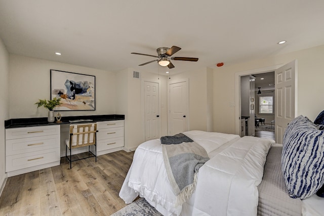 bedroom with light hardwood / wood-style floors and ceiling fan