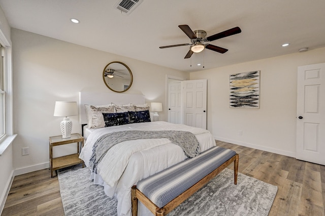 bedroom with ceiling fan and light wood-type flooring