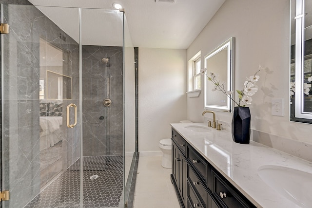 bathroom featuring vanity, an enclosed shower, and toilet