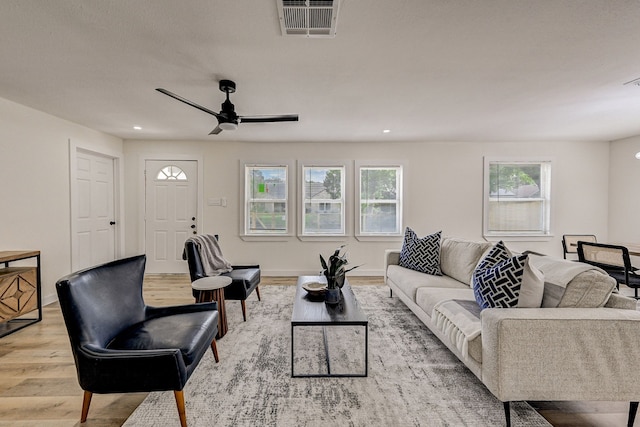 living room with ceiling fan and light wood-type flooring