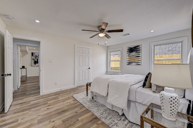 bedroom with ceiling fan and light hardwood / wood-style flooring