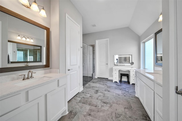 bathroom featuring vanity, a shower with shower door, and lofted ceiling