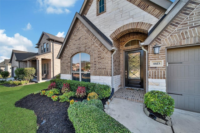 entrance to property with a yard and a garage