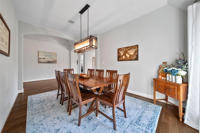 dining space with dark hardwood / wood-style floors