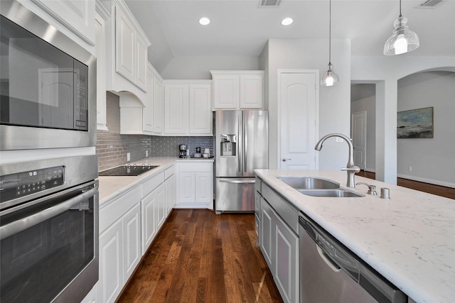 kitchen with white cabinetry, sink, tasteful backsplash, pendant lighting, and appliances with stainless steel finishes