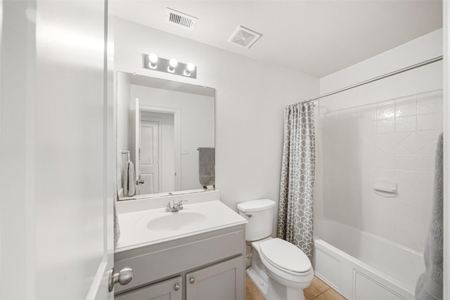 full bathroom featuring tile patterned floors, vanity, toilet, and shower / bath combo with shower curtain