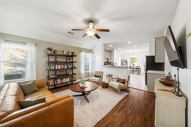 living room featuring ceiling fan and hardwood / wood-style floors