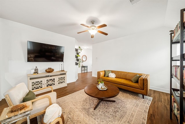 living room featuring dark hardwood / wood-style flooring and ceiling fan