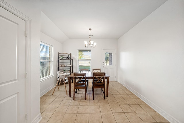 tiled dining room with vaulted ceiling and a notable chandelier