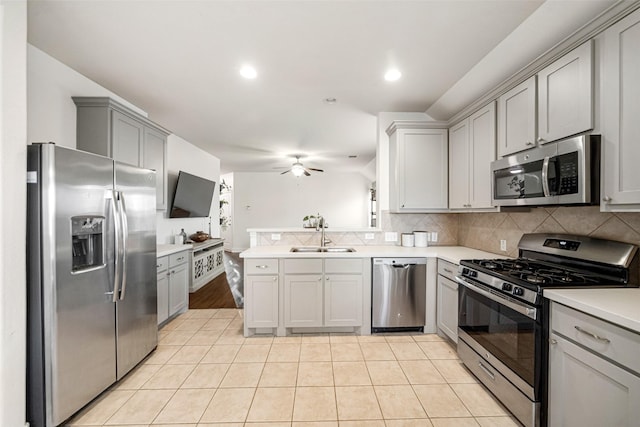 kitchen featuring sink, ceiling fan, gray cabinets, light tile patterned floors, and appliances with stainless steel finishes