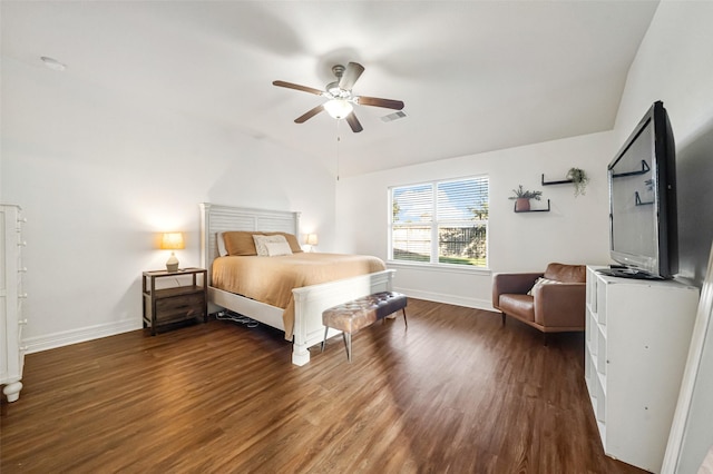 bedroom with vaulted ceiling, ceiling fan, and dark wood-type flooring