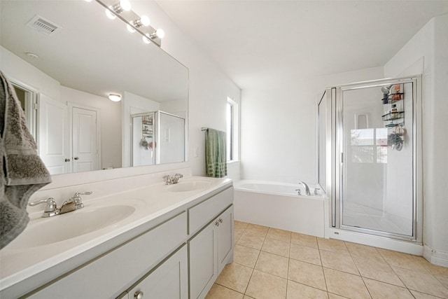 bathroom featuring tile patterned floors, vanity, and shower with separate bathtub