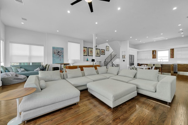 living room featuring ceiling fan, dark hardwood / wood-style floors, and sink