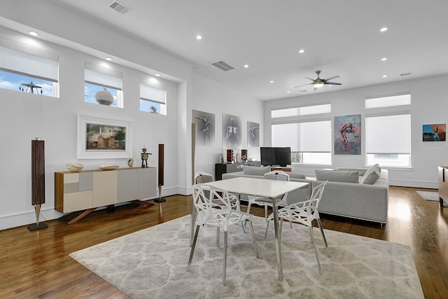 dining area featuring ceiling fan and dark hardwood / wood-style flooring