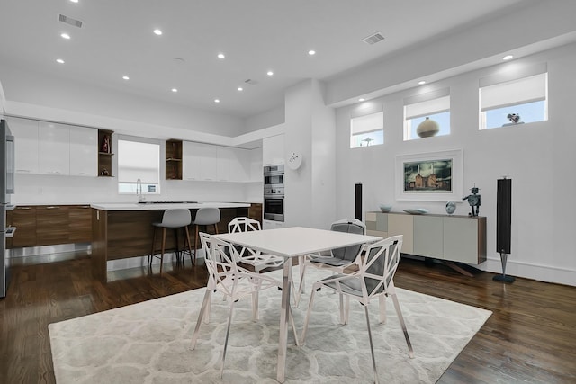 dining area featuring dark hardwood / wood-style floors, sink, and a wealth of natural light