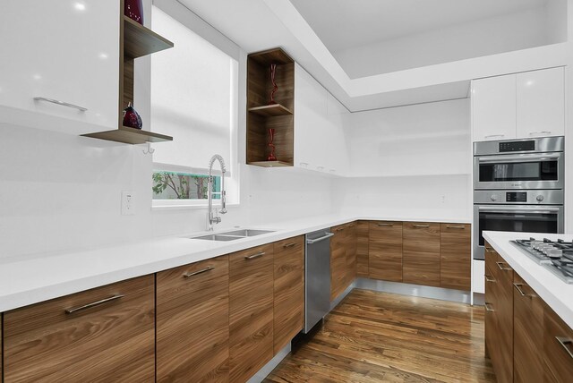 kitchen featuring dark hardwood / wood-style floors, sink, white cabinets, and double oven