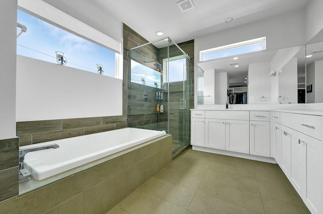 bathroom with tile patterned floors, shower with separate bathtub, and vanity